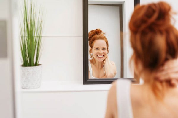 woman smiling in the mirror