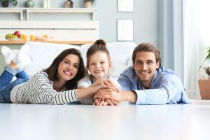 family of three all smiling