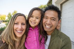 family of three all smiling