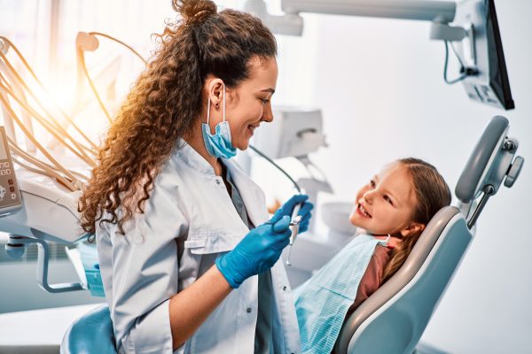 Little girl smiles at dentist