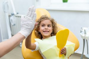 Little girl high-fives dentist